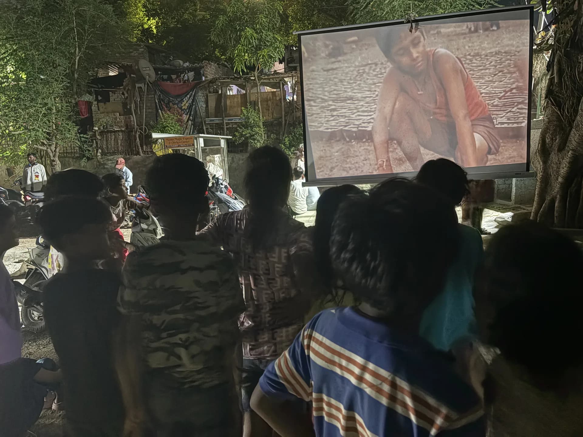 A crowd focused on the story unfolding on screen